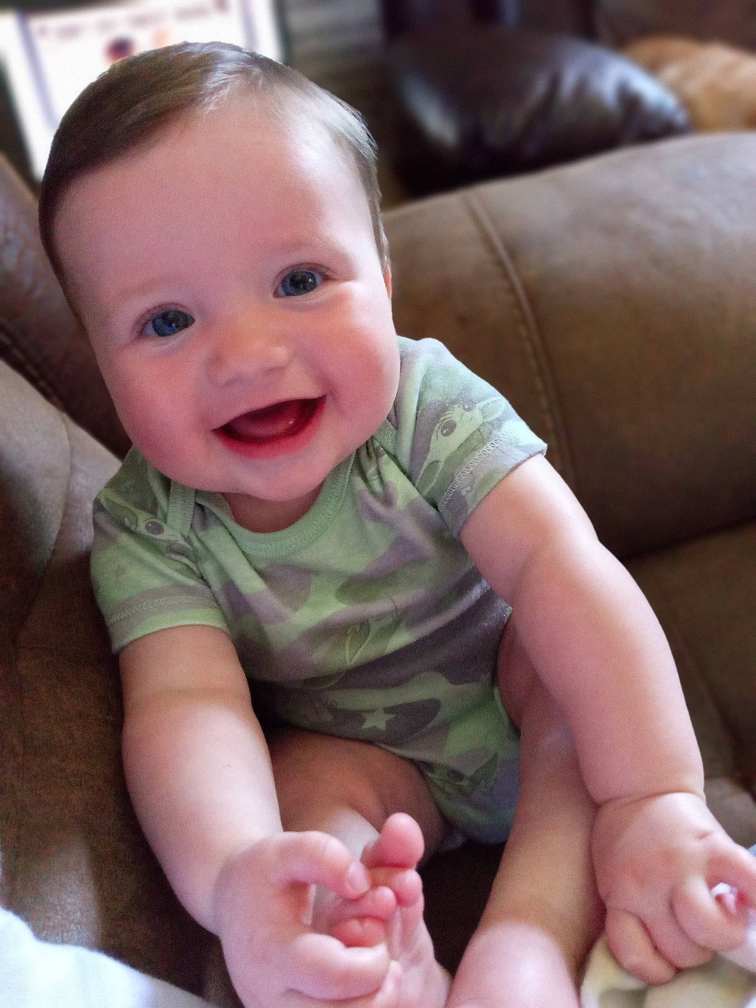 Grayson is registered to the contest to win money with this photo: arm, baby, baby_toddler_clothing, cheek, chin, comfort, face, finger, gesture, hand, happy, head, joy, leg, lip, mouth, nose, person, photograph, skin