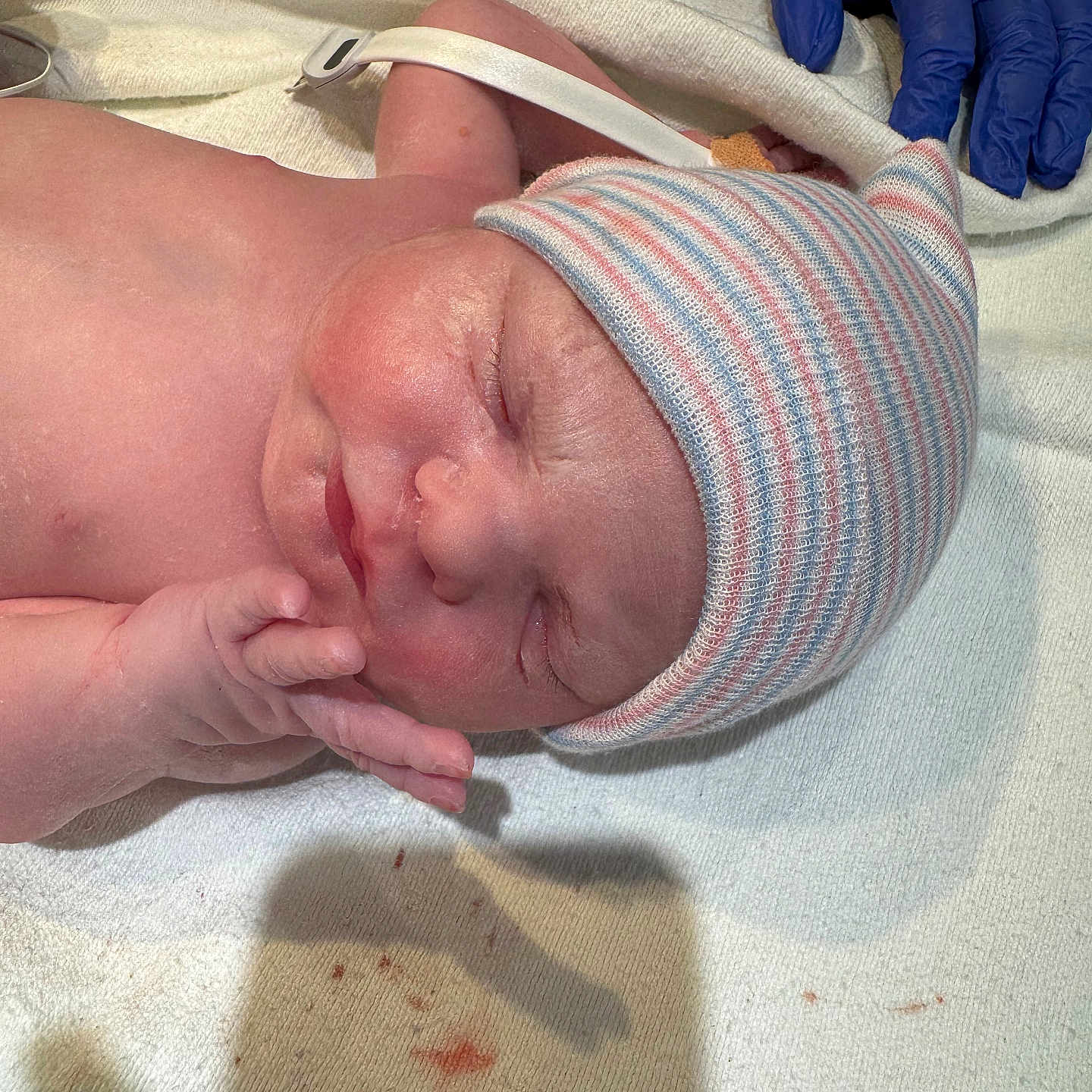 Irene joined the competition — help win amazing prizes! baby, child, closeup, delivery, gloved_hand, hand, hat, healthcare, hospital, infant, medical, newborn, newborn_baby, peaceful, person, resting, skin, sleeping, striped_hat, towel