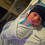 newborn, baby, hospital, blanket, swaddled, hat, bassinet, infant, bed, face, person, sleeping, cute, child, newborn_care, healthcare, portrait, resting, wrapped, hospital_room