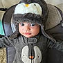 adorable, apparel, baby, blue_eyes, child, clothing, cute, expression, face, fuzzy_hat, hat, indoor, infant, onesie, penguin_design, portrait, sitting, soft_texture, warm_clothing, young
