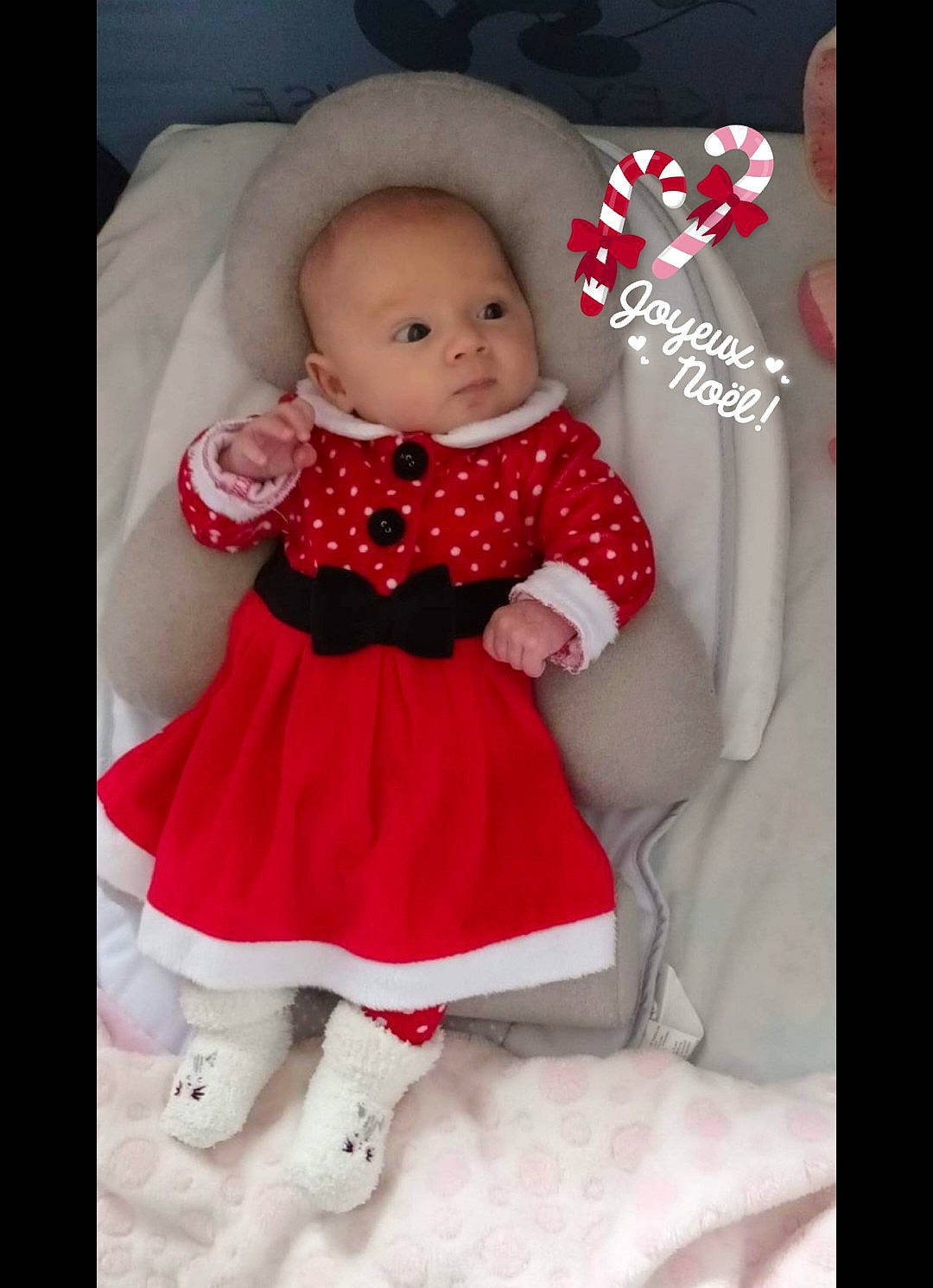 Arya participe au concours pour gagner de l'argent avec cette photo : baby, baby_products, baby_toddler_clothing, carmine, child, doll, dress, event, formal_wear, happy, magenta, pattern, peach, person, petal, pink, room, sitting, sleeve, textile