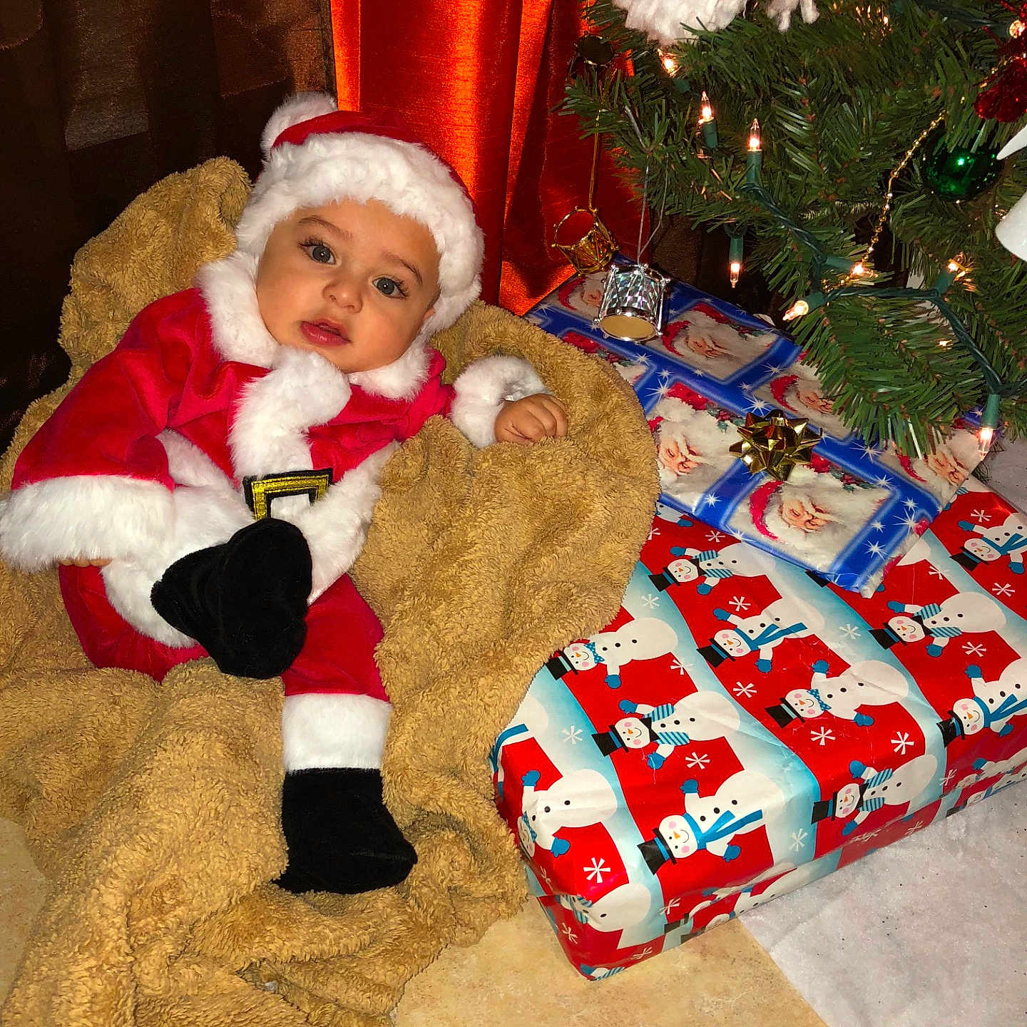 Aaron is registered to the contest to win money with this photo: christmas, christmas_decoration, christmas_ornament, christmas_stocking, event, fictional_character, holiday, lap, product, santa_claus, toddler