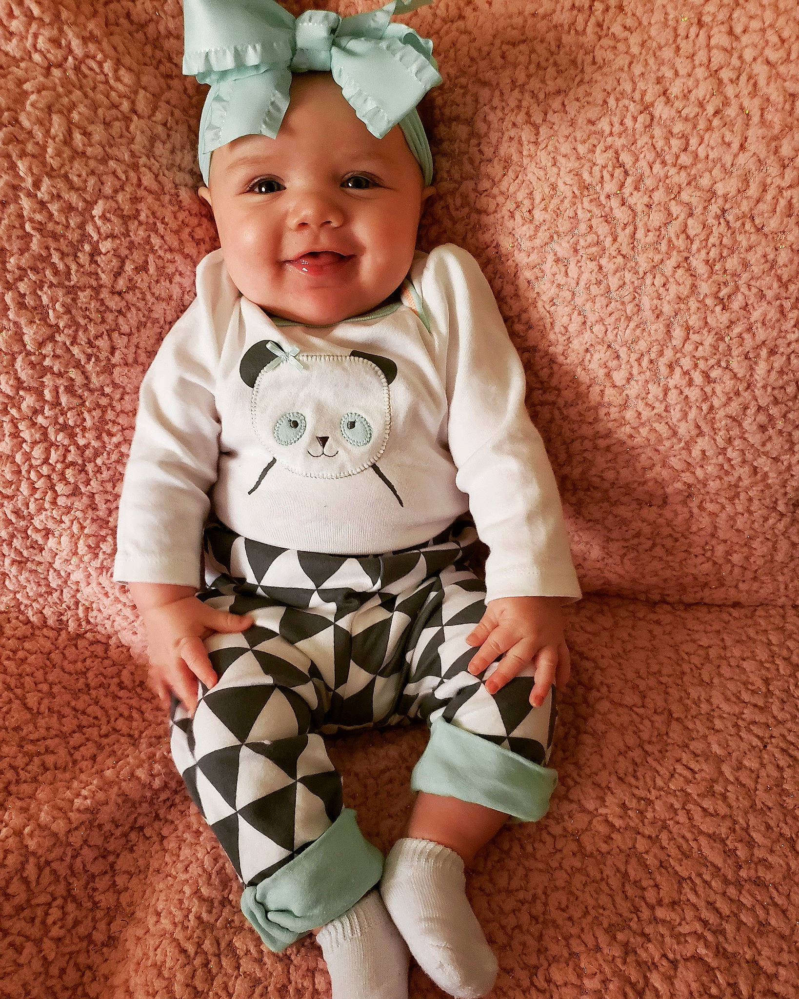 Maya is registered to the contest to win money with this photo: baby, baby_bloomers, baby_products, baby_toddler_clothing, child, headgear, pattern, person, product, sleeve, smile, toddler