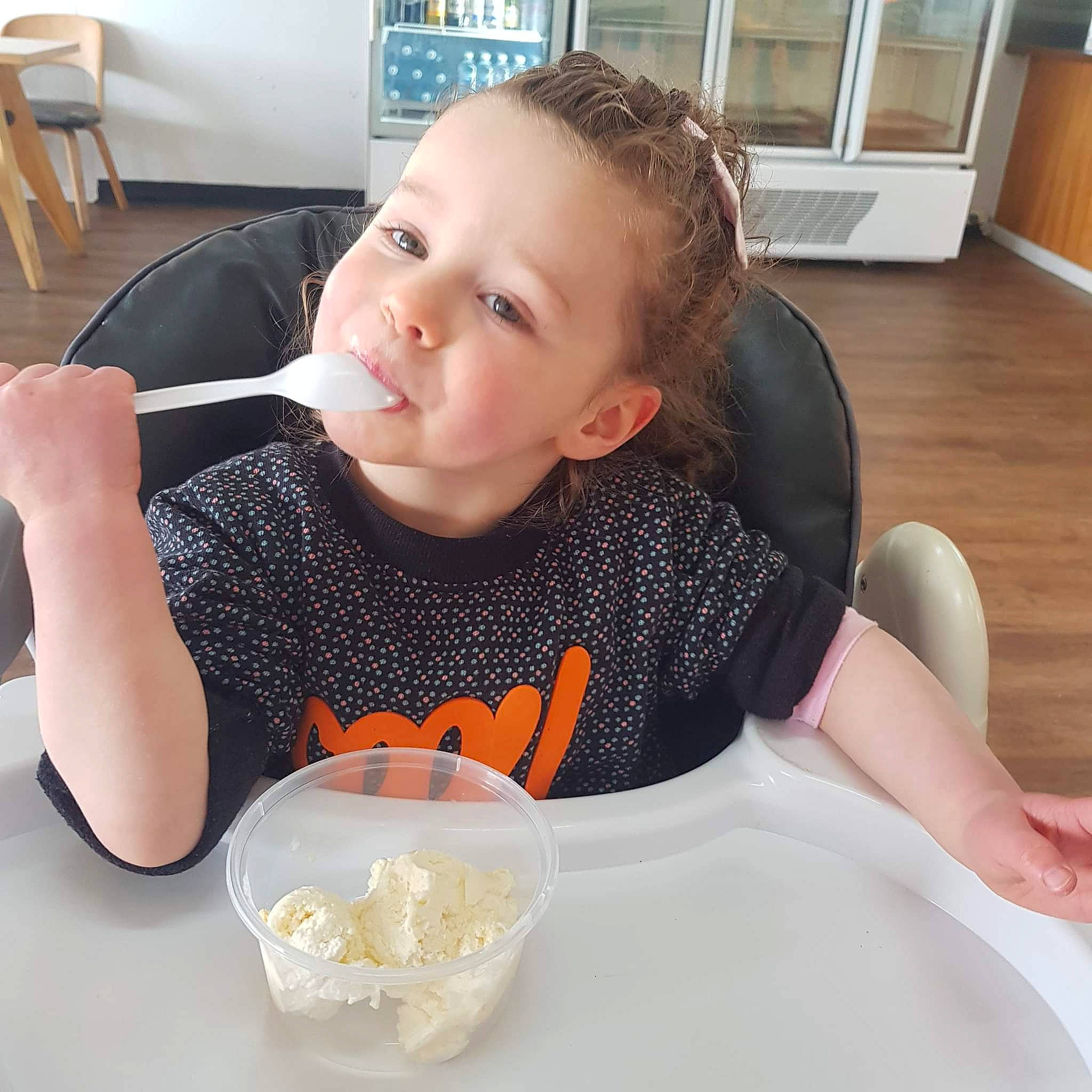 Lilly-anne is registered to the contest to win money with this photo: chair, child, comfort_food, cooking, cuisine, dish, dishware, drinkware, eating, finger, food, food_craving, ingredient, person, plate, serveware, sleeve, spoon, table, tableware