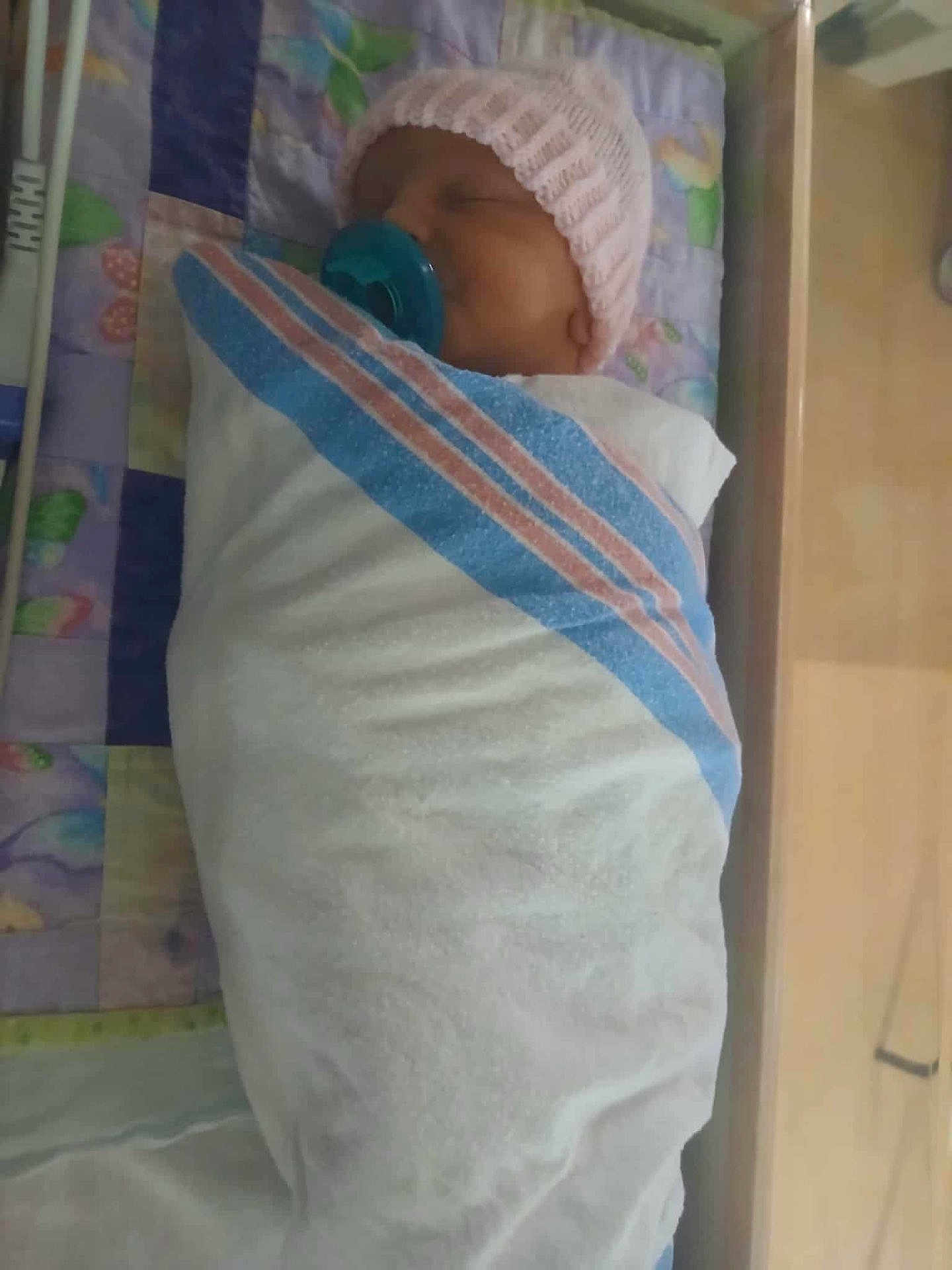 Brinnleigh is registered to the contest to win money with this photo: newborn, baby, infant, pacifier, blanket, crib, sleeping, hospital, hat, child, swaddled, bed, bedding, person, resting, cute, indoors, soft, comfort, peaceful
