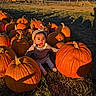 baby, child, pumpkin, pumpkin_patch, farm, outdoor, autumn, fall, harvest, halloween, portrait, sitting, hat, sweater, smiling, sunlight, golden_hour, mountains, clouds, fence