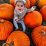 baby, child, infant, smiling, happy, pumpkin, pumpkin_patch, halloween, outdoor, autumn, fall, nature, grass, portrait, sitting, baby_clothing, knit_hat, bonnet, orange, harvest