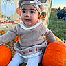 Persephone joined the competition — help win amazing prizes! baby, child, infant, portrait, sitting, pumpkin_patch, pumpkins, autumn, fall, knit_hat, bow, sweater, romper, white_tights, hay, farm, outdoor, smiling, face, colorful_background