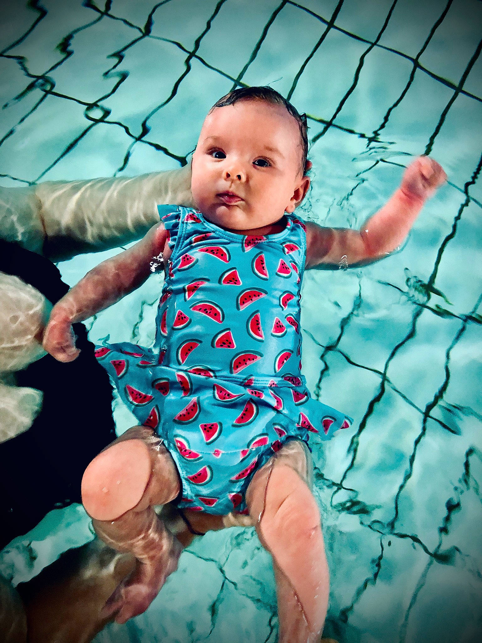 Theia is registered to the contest to win money with this photo: aqua, baby, baby_products, baby_toddler_clothing, child, fun, leisure, person, recreation, skin, smile, toddler, turquoise, water