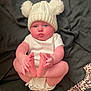 Delilah is registered to the contest to win money with this photo: baby, infant, hat, knit_hat, pom_poms, white_clothing, diaper, hands, feet, blue_eyes, blanket, lying_down, cute, chubby_cheeks, indoor, soft_texture, child, person, portrait, curious