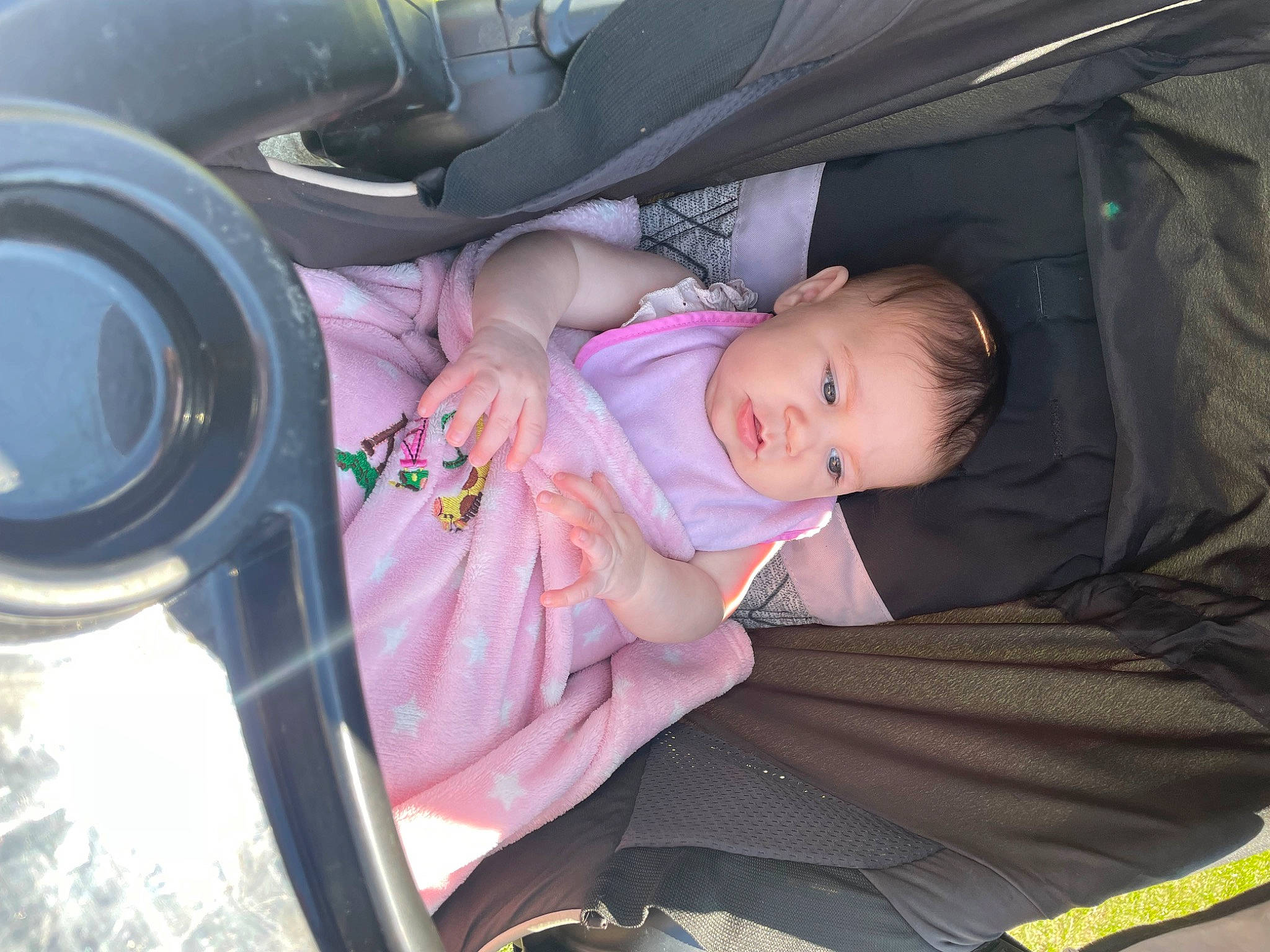 Kayla is registered to the contest to win money with this photo: auto_part, baby, baby_carriage, baby_products, baby_toddler_clothing, car_seat, child, comfort, facial_expression, finger, fun, hand, human, luxury_vehicle, mammal, nail, person, sitting, toddler, tree