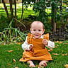 Aurora is registered to the contest to win money with this photo: baby, child, grass, autumn_leaves, orange_dress, barefoot, outdoor, greenery, trees, garden, smiling, sitting, nature, young_child, cute, portrait, fall, daylight, happy, person