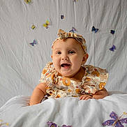Aurora joined the competition — help win amazing prizes! baby, child, smiling, headband, floral_dress, blanket, butterflies, white_background, cute, portrait, happy, infant, decorations, soft_lighting, indoors, baby_girl, colorful, playful, lying_down, closeup