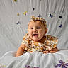 Aurora joined the competition — help win amazing prizes! baby, child, smiling, headband, floral_dress, blanket, butterflies, white_background, cute, portrait, happy, infant, decorations, soft_lighting, indoors, baby_girl, colorful, playful, lying_down, closeup