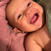Luca joined the competition — help win amazing prizes! baby, smiling, tongue_out, blanket, cozy, happy, face, skin, infant, child, cute, portrait, closeup, soft_texture, pink_blanket, green_blanket, lying_down, bare_shoulders, cheerful, expressive