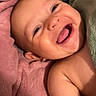 baby, smiling, tongue_out, blanket, cozy, happy, face, skin, infant, child, cute, portrait, closeup, soft_texture, pink_blanket, green_blanket, lying_down, bare_shoulders, cheerful, expressive