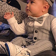 Antonio is registered to the contest to win money with this photo: baby, infant, child, bow_tie, pinstripe_suit, newsboy_cap, sneakers, white_shoes, sitting, side_profile, cheeks, hand, fabric_pattern, blanket, bed, portrait, cute, formal_attire, soft_lighting, indoor
