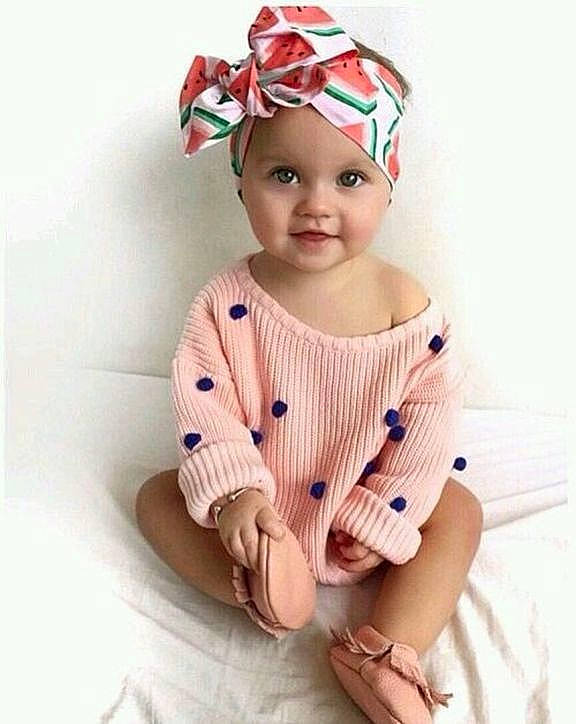 Daisy joined the competition — help win amazing prizes! baby, baby_toddler_clothing, beanie, beige, cap, child, child_model, clothing, fashion_accessory, hair_accessory, headgear, headwear, outerwear, pattern, peach, person, pink, product, sleeve, smile
