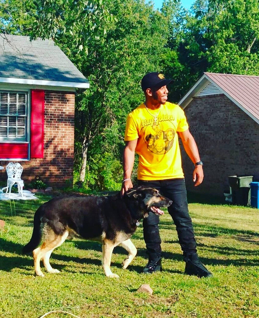 Nino joined the competition — help win amazing prizes! carnivore, chair, companion_dog, dog, dog_breed, german_shepherd_dog, grass, hat, herding_dog, house, leisure, mammal, old_german_shepherd_dog, plant, recreation, shorts, t_shirt, tree, vertebrate, window