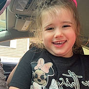 Harper joined the competition — help win amazing prizes! child, smiling, girl, car_interior, seat, hair_bow, tshirt, minnie_mouse, graphic_tee, happy, portrait, casual, window, seatbelt, daylight, cute, young_child, person, fun, indoors