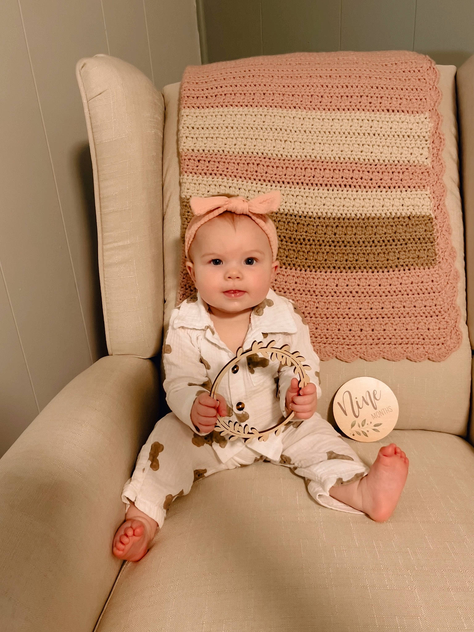 Nora is registered to the contest to win money with this photo: baby, baby_sleeping, baby_toddler_clothing, chair, child, comfort, couch, eye, face, head, leg, linens, pattern, person, pillow, sitting, sleeve, thigh, throw_pillow, toddler