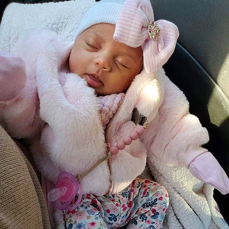 Isabella is registered to the contest to win money with this photo: baby, baby_sleeping, baby_toddler_clothing, bedding, cap, child, comfort, fashion_accessory, finger, fur, headwear, knit_cap, linens, nail, person, pink, skin, textile, thumb, toddler