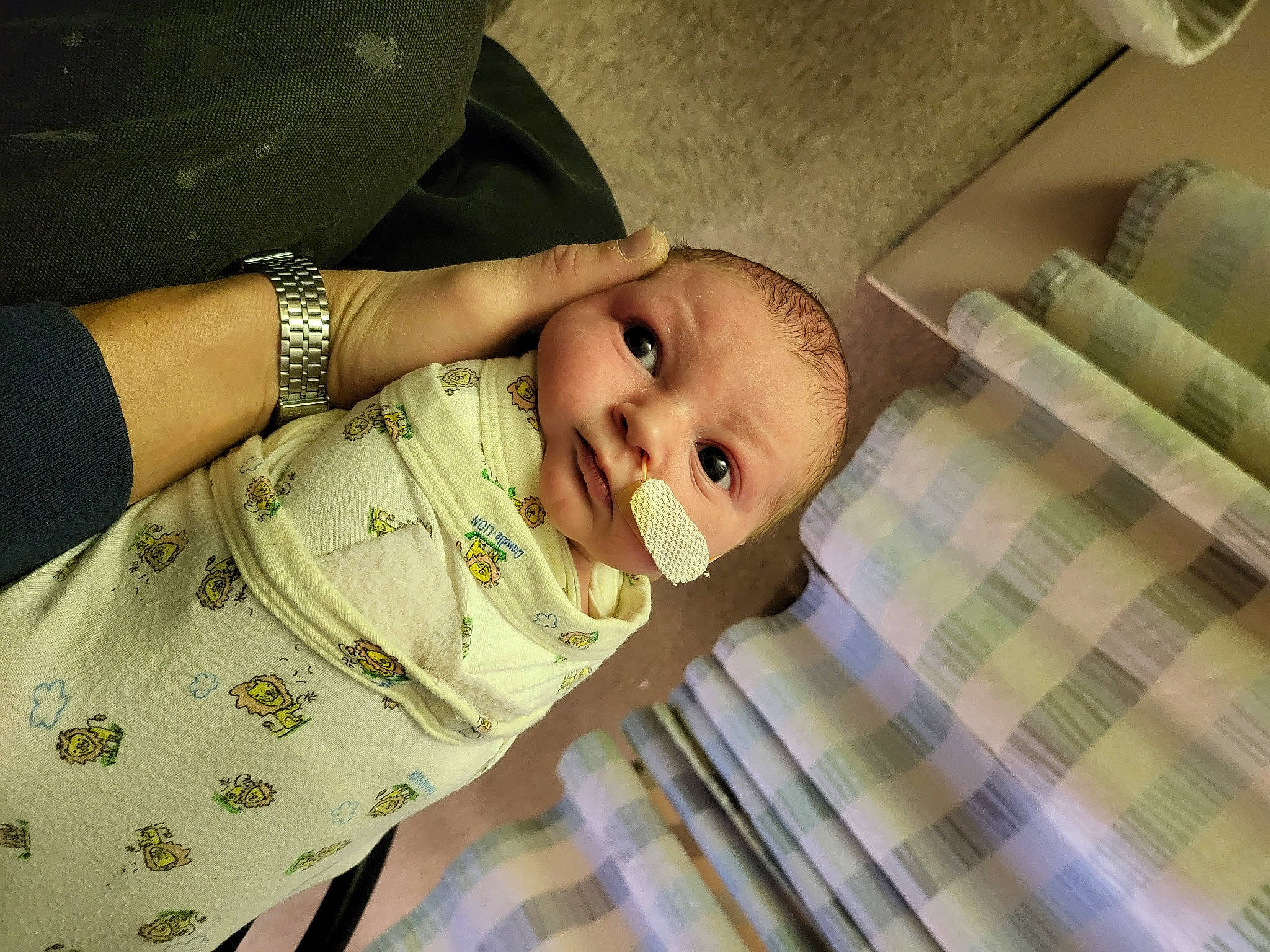 Bentlee is registered to the contest to win money with this photo: arm, baby, baby_toddler_clothing, cheek, child, comfort, elbow, eye, gesture, happy, linens, nose, pattern, person, plaid, sitting, sleeve, smile, tartan, toddler