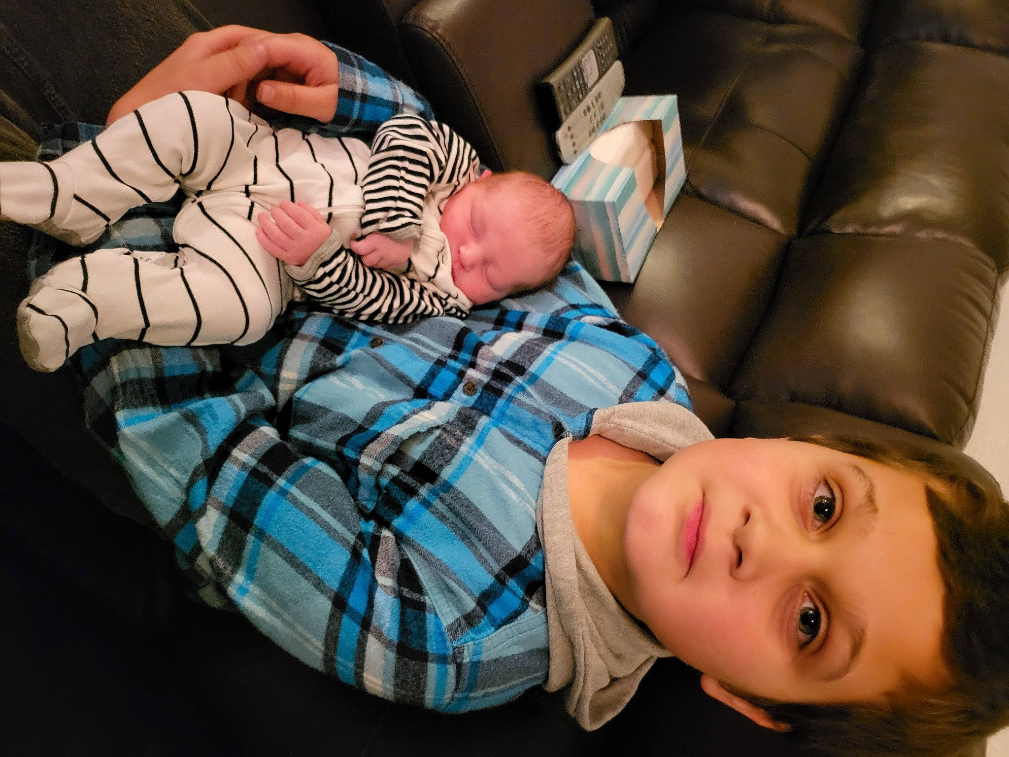 Bentlee is registered to the contest to win money with this photo: baby, child, comfort, couch, flash_photography, fun, human_body, human_leg, lap, leg, pattern, people, person, plaid, room, sitting, sock, tartan, thumb, toddler