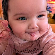 Aria joined the competition — help win amazing prizes! baby, infant, child, portrait, close_up, face, smiling, tongue_out, rosy_cheeks, blue_eyes, brown_hair, pink_clothing, bib, long_sleeves, hand, indoor, cozy, happy, adorable, photography