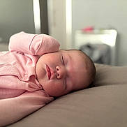 Isla is registered to the contest to win money with this photo: baby, sleeping, infant, pink_clothing, closeup, face, peaceful, soft_focus, indoors, portrait, newborn, cute, child, resting, head, skin, lying_down, warm, calm, cozy