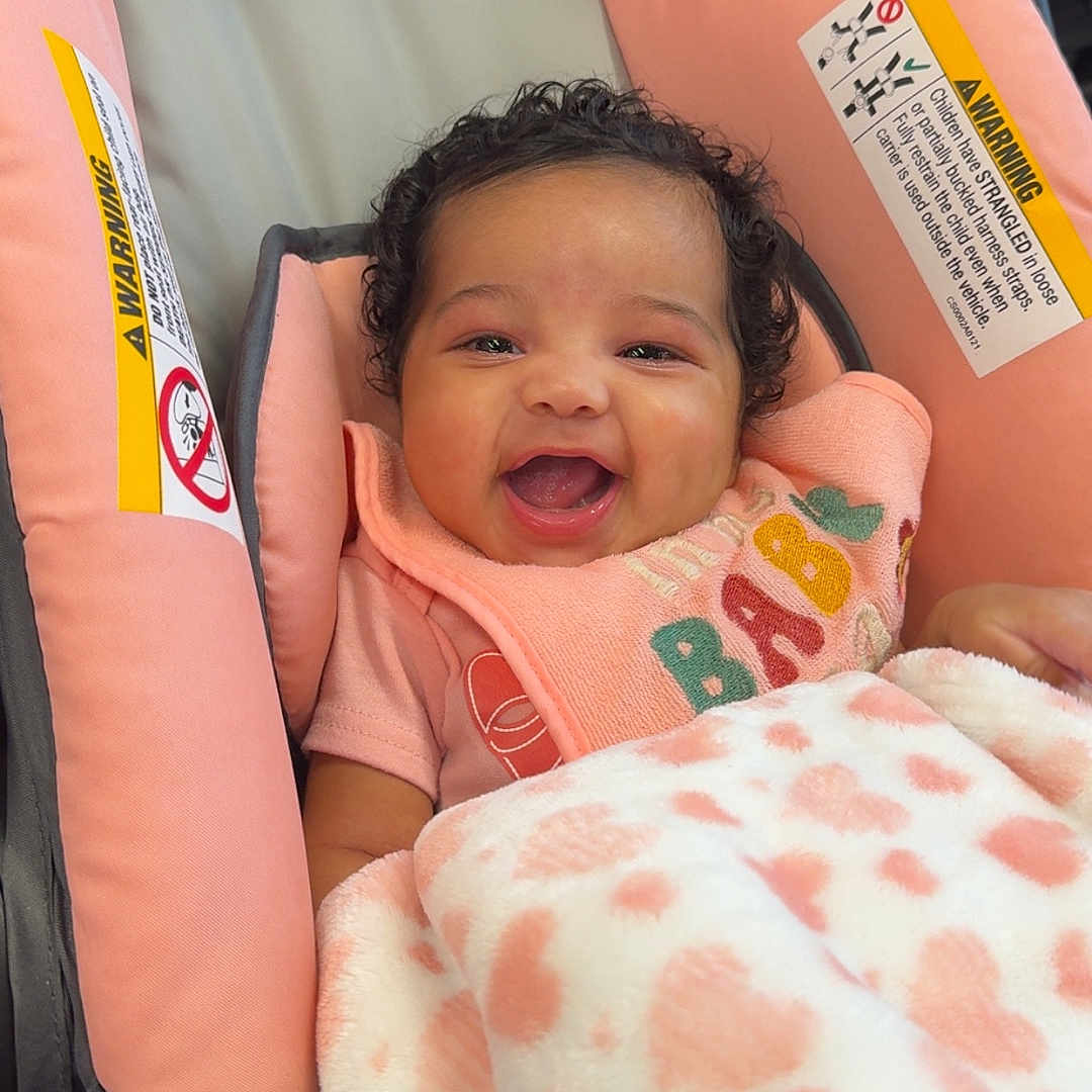 Naylani joined the competition — help win amazing prizes! baby, blanket, car, car_interior, carseat, crib, cushion, face, furniture, head, homedecor, infantbed, newborn, person, photography, portrait, sleeping, stroller, transportation, vehicle