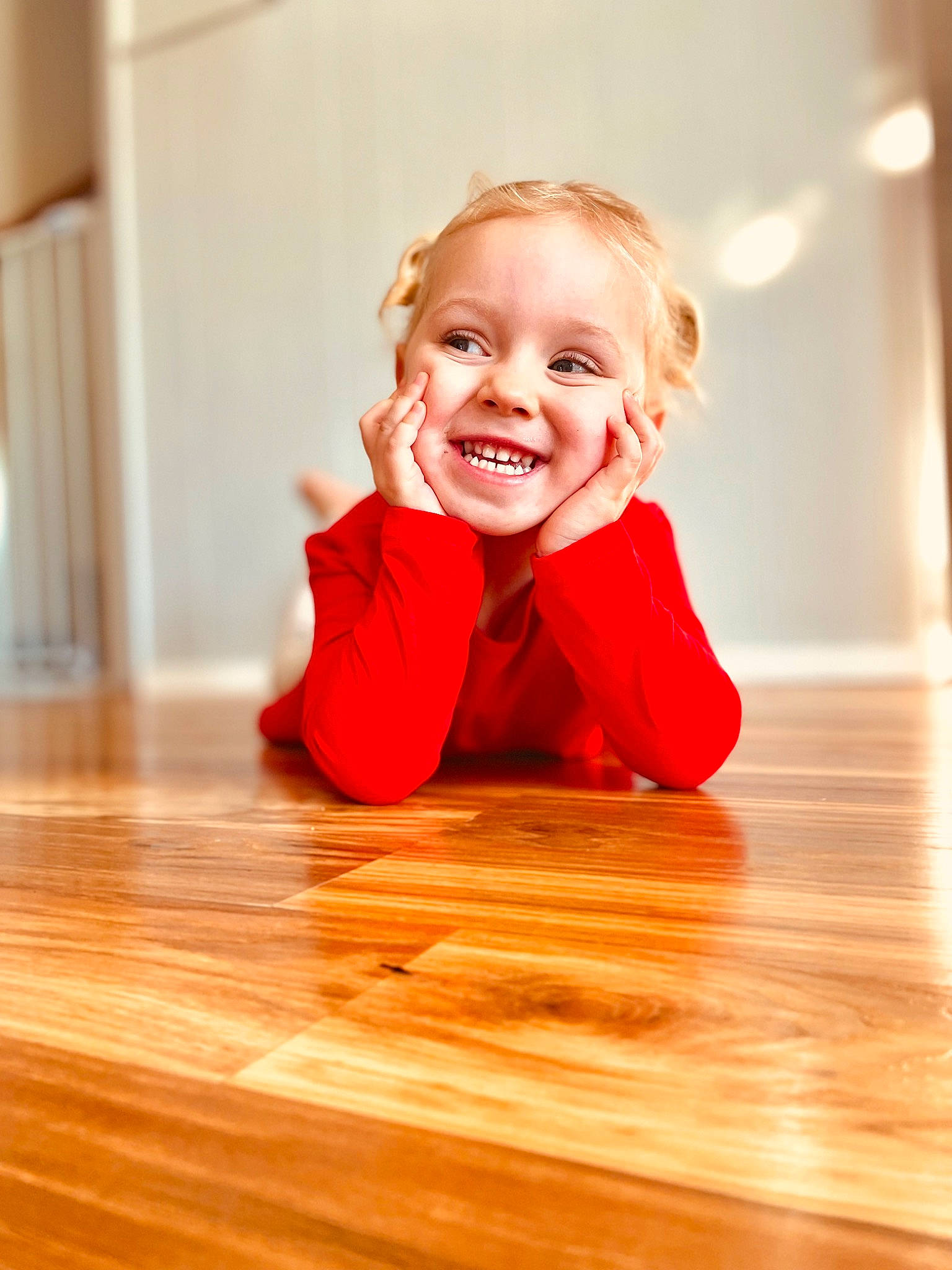 Vada joined the competition — help win amazing prizes! brown_hair, floor, flooring, fun, happy, hardwood, human_leg, joy, laminate_flooring, pattern, person, plank, plywood, sitting, skin, smile, table, toddler, varnish, wood