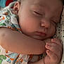 Anakin joined the competition — help win amazing prizes! baby, sleeping, infant, onesie, dinosaur_print, blanket, cuddling, peaceful, closeup, face, hand, soft, indoor, plush_toy, child, cute, resting, newborn, cozy, portrait