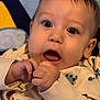 Anakin is registered to the contest to win money with this photo: adorable, baby, blanket, child, clothing, cute, expression, face, hands, indoors, infant, onesie, open_mouth, person, portrait, sitting, sleepwear, soft_texture, wide_eyes, young