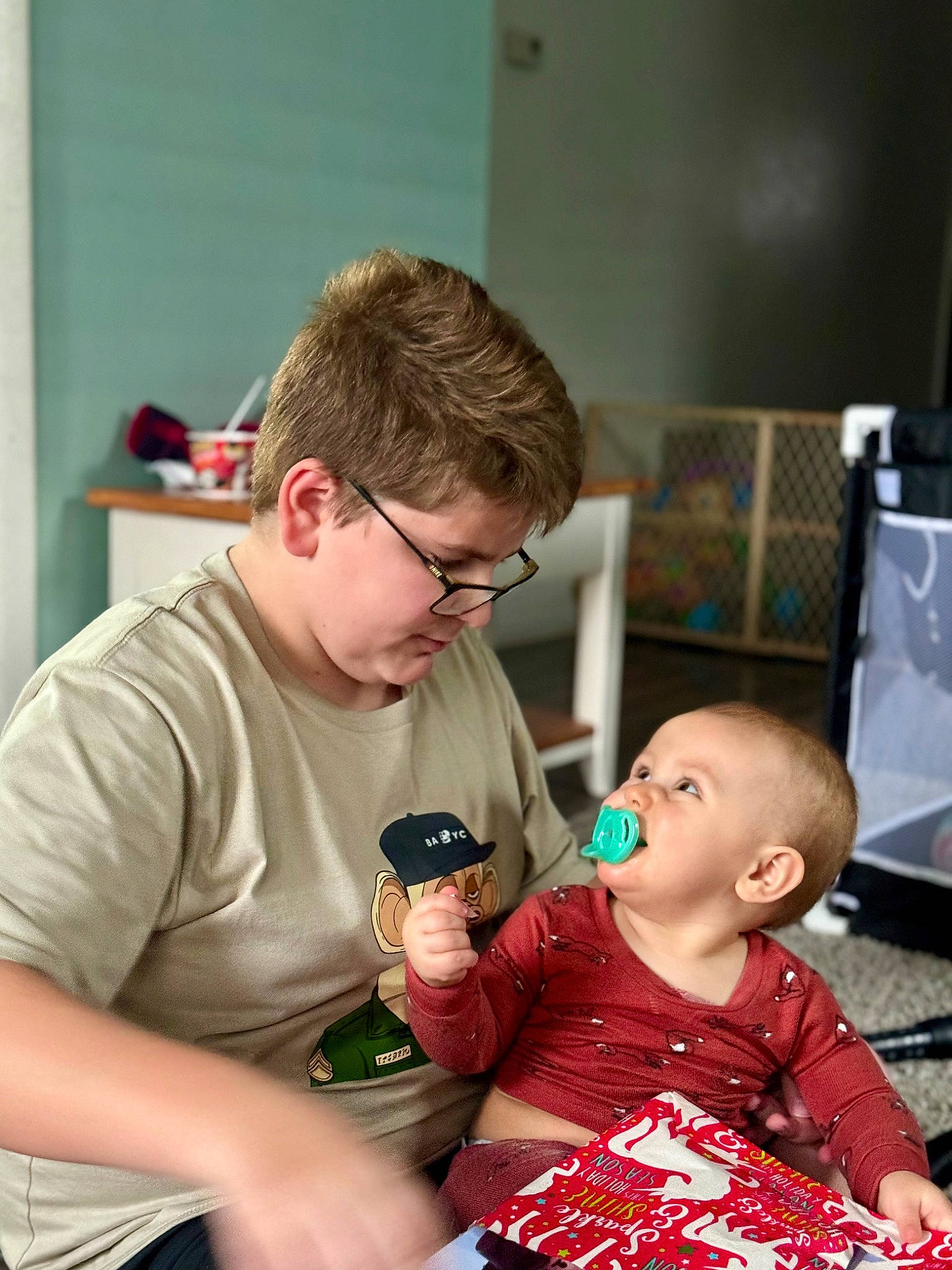 Sawyer is registered to the contest to win money with this photo: baby, child, event, eyewear, fun, glasses, happy, holiday, lap, person, play, room, sitting, t_shirt, toddler, vacation, vision_care