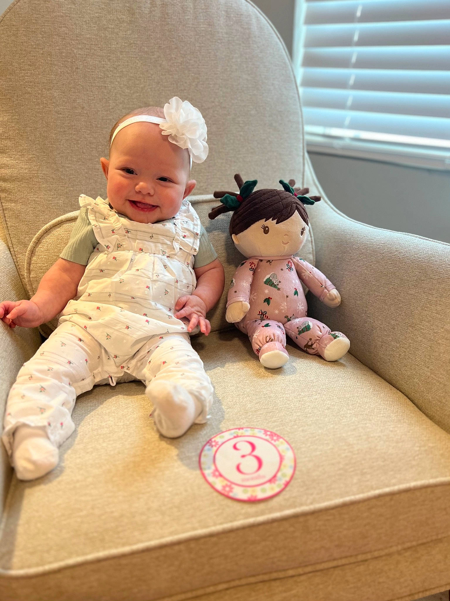 Jordyn is registered to the contest to win money with this photo: baby, baby_toddler_clothing, baby_toys, child, comfort, doll, finger, flooring, happy, joy, person, sitting, skin, smile, stuffed_toy, table, textile, toddler, toy, window