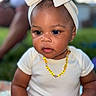 Skhylar joined the competition — help win amazing prizes! baby, child, headwrap, bow, necklace, outdoor, portrait, cute, infant, white_clothing, skin, earrings, face, expression, person, young, sitting, curious, soft_light, blurred_background