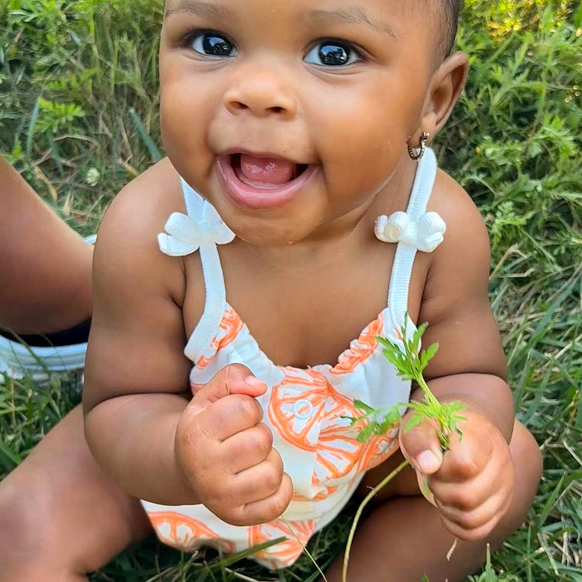 Skhylar joined the competition — help win amazing prizes! baby, child, grass, outdoor, smile, happy, plant, greenery, nature, infant, cute, sitting, clothing, earrings, skin, sunlight, portrait, hands, face, summer