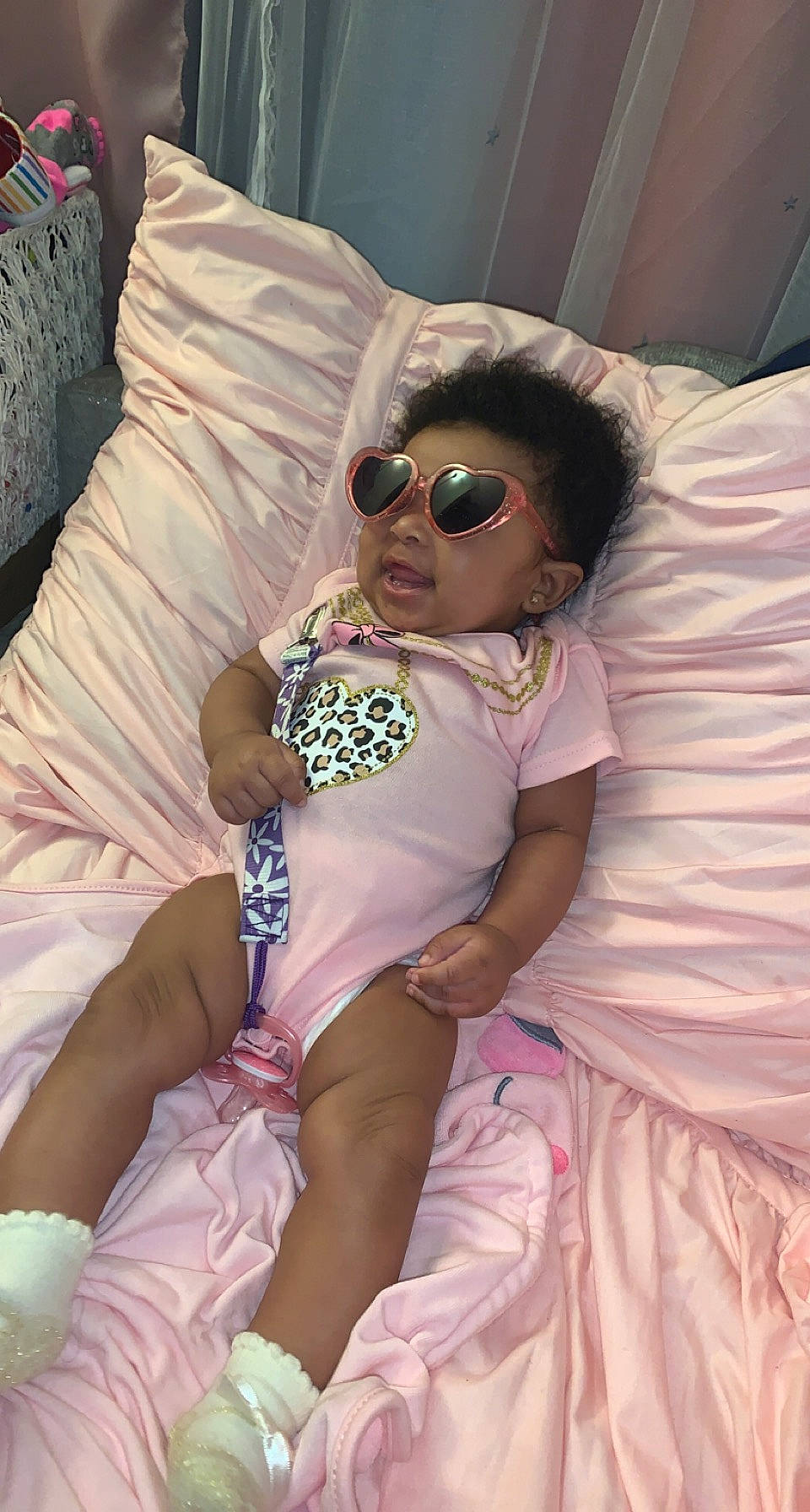 Aryah is registered to the contest to win money with this photo: baby, baby_toddler_clothing, child, comfort, eyewear, face, glasses, goggles, hat, human, mammal, person, pink, purple, skin, sunglasses, textile, thigh, toddler, violet