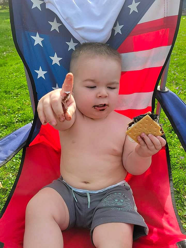 Harrison is registered to the contest to win money with this photo: arm, baby, beauty, blue, chest, child, finger, flag, fun, gesture, grass, happy, leisure, muscle, person, plant, red, thigh, thumb, toddler