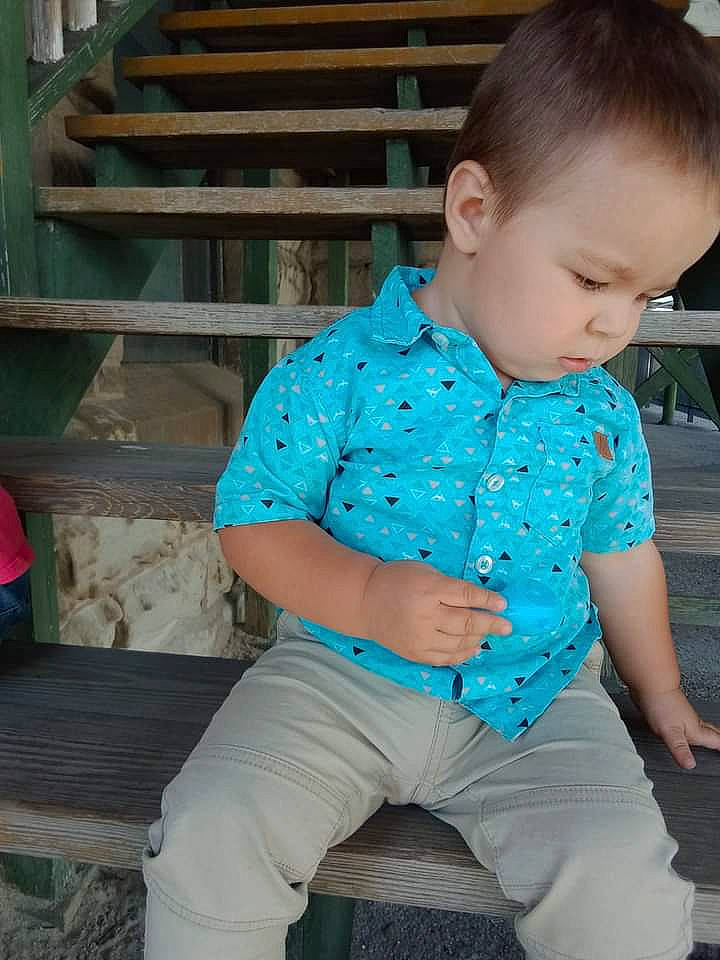 Harrison is registered to the contest to win money with this photo: baby_toddler_clothing, denim, electric_blue, facial_expression, fun, grass, happy, human_body, human_leg, knee, leisure, neck, pattern, person, skin, sleeve, thigh, toddler, trunk, waist