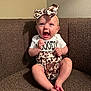 baby, child, infant, couch, brown, happy, smiling, headband, leopard_print, clothing, sitting, indoors, cute, portrait, person, small_feet, cheerful, expression, one_person, casual
