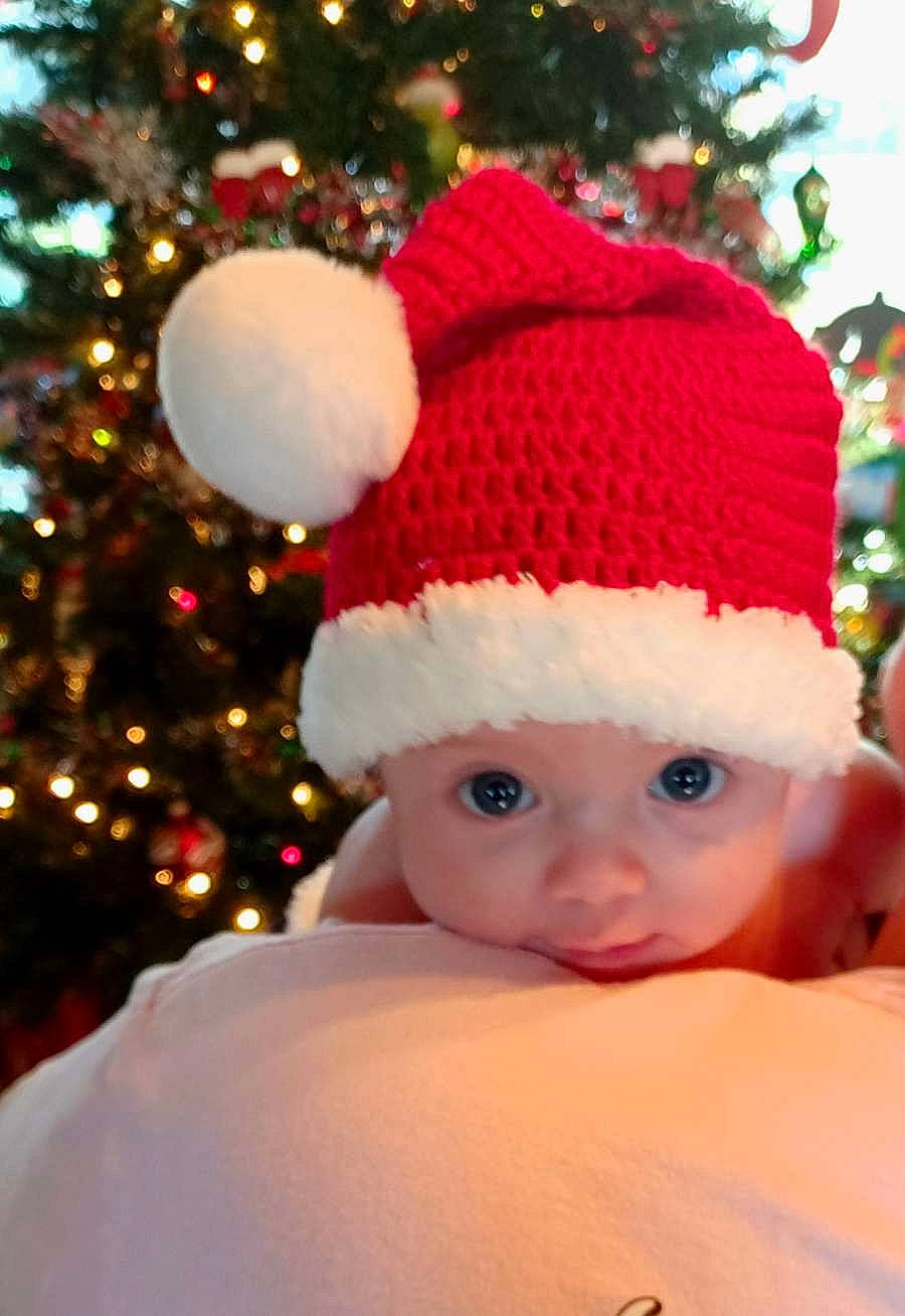 Wyatt is registered to the contest to win money with this photo: baby_toddler_clothing, cap, christmas, christmas_decoration, christmas_ornament, christmas_tree, event, evergreen, fur, happy, head, headwear, holiday, holiday_ornament, knit_cap, light, ornament, person, plant, toddler