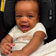 Zackaron joined the competition — help win amazing prizes! baby, smiling, infant, car_seat, child, cute, happy, face, hands, clothing, seatbelt, indoors, portrait, toddler, curly_hair, skin, expression, closeup, comfort, blanket