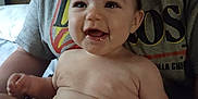 Wynter is registered to the contest to win money with this photo: baby, smiling, drool, diaper, adult, indoor, person, tshirt, happy, child, face, skin, hand, lap, seated, closeup, infant, casual, expression, portrait