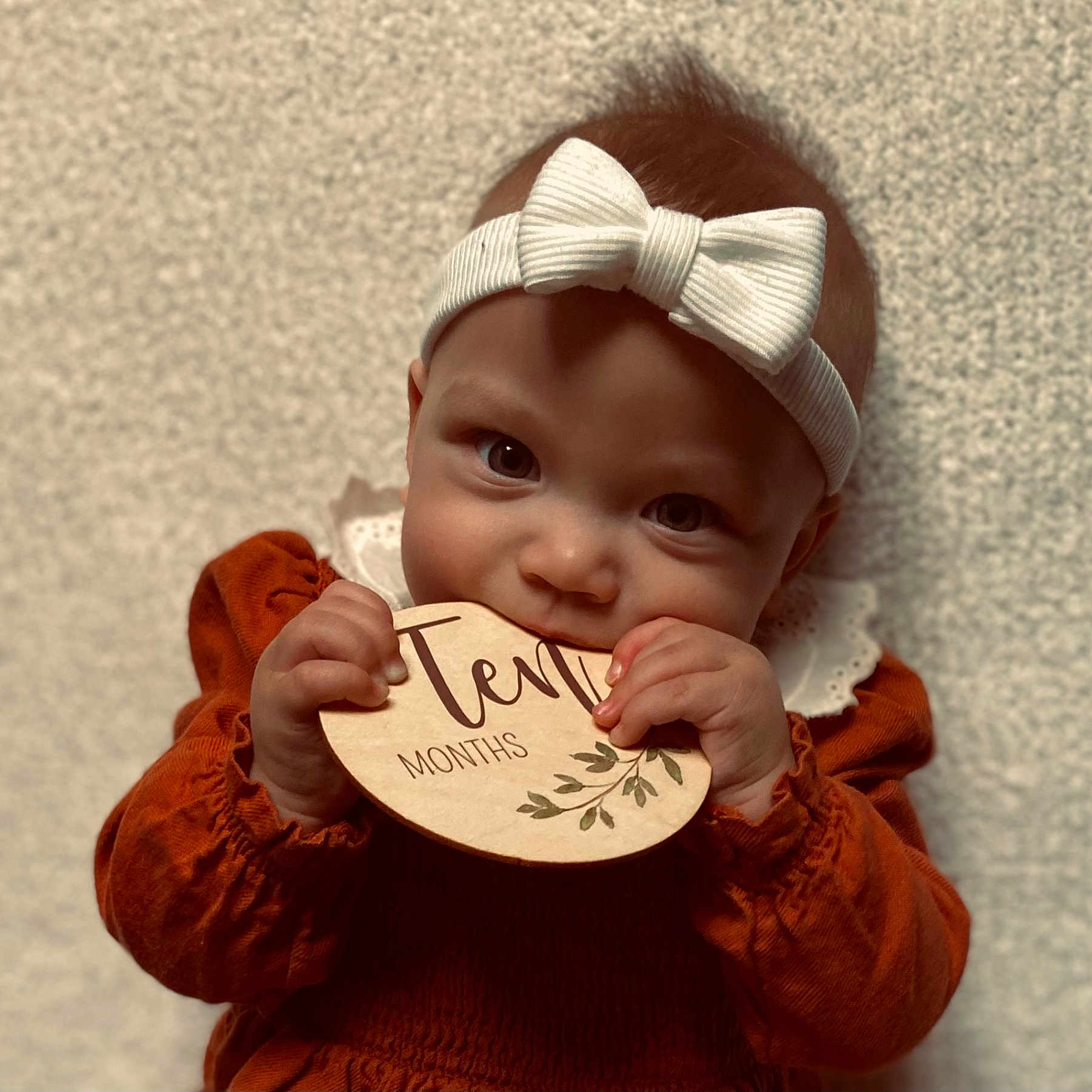 Serenity is registered to the contest to win money with this photo: accessories, baby, biting, bodypart, clothing, coat, face, finger, hand, happy, hat, head, jacket, knitwear, newborn, person, photography, portrait, smile, sweater