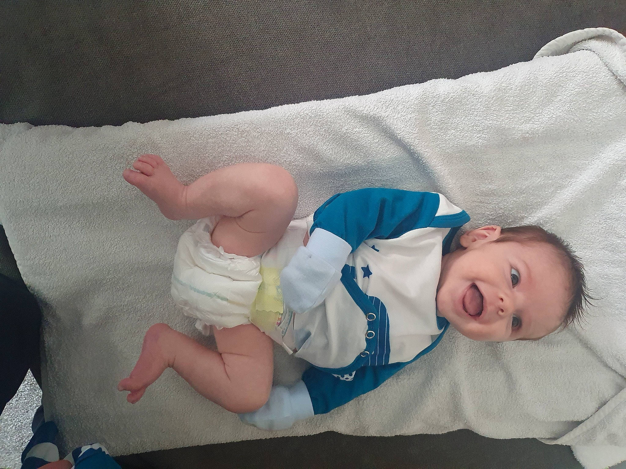 Elijah is registered to the contest to win money with this photo: baby, baby_products, baby_sleeping, baby_toddler_clothing, comfort, diaper, elbow, finger, gesture, hand, human_body, knee, linens, person, skin, sleeve, smile, sock, textile, thumb