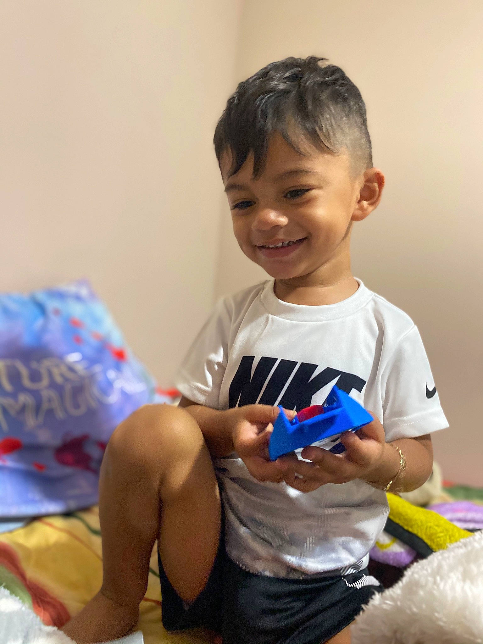 Iker is registered to the contest to win money with this photo: active_shirt, ankle, baby_playing_with_toys, baby_toddler_clothing, baby_toys, child, foot, glove, joy, lap, nail, person, plastic, play, sock, stuffed_toy, toddler, toy