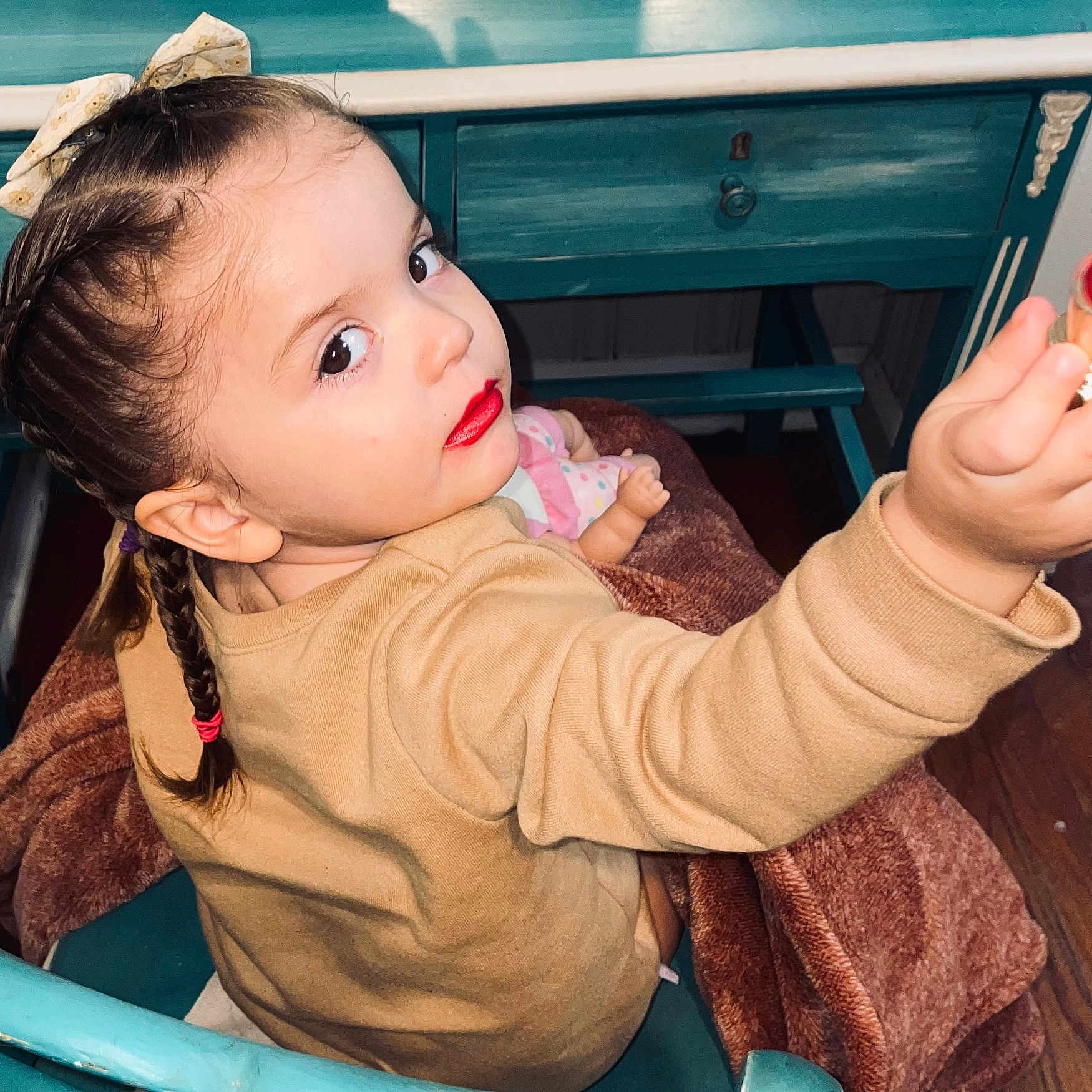Sofia is registered to the contest to win money with this photo: baby, biting, bodypart, braid, clothing, cosmetics, eating, face, finger, food, hair, happy, head, lipstick, person, photography, portrait, sitting, sleeve, smile