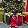 Ayla is registered to the contest to win money with this photo: baby, black_headband, bright_colors, celebration, child, christmas_tree, curious, decorations, festive, floor, gift_boxes, holiday_decor, indoors, ornaments, presents, red_dress, seated, shoes, toddler, winter